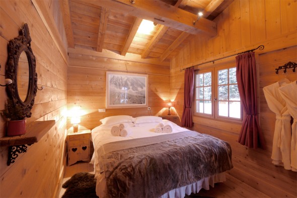 Upstairs bedroom with doors to balcony