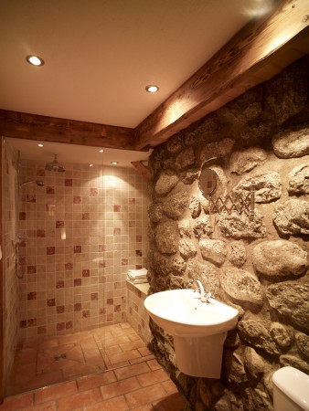 Downstairs wet room with exposed granite wall