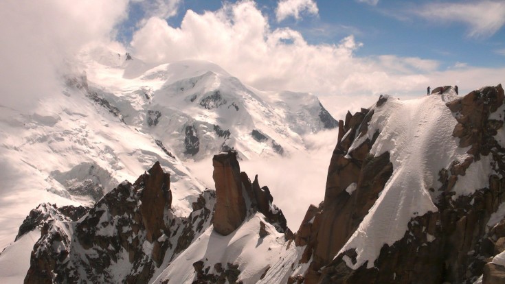Mont Blanc and climbers on the Arête des Cosmiques, seen from the Aiguille du Midi