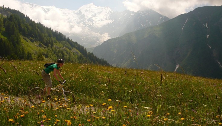 Mountain biking in summer in front of Mont Blanc